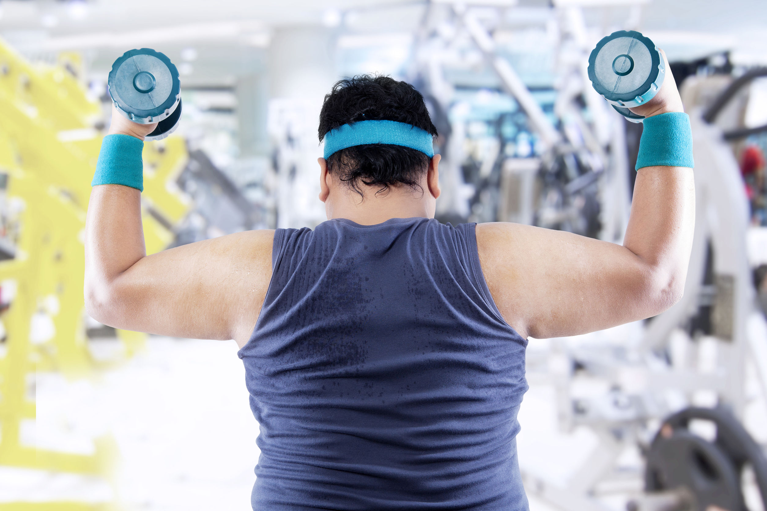 obese man exercising in gym